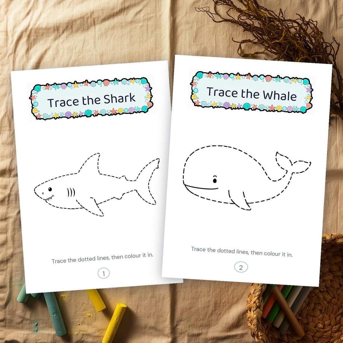 Two printed tracing pages, a shark and a whale in dashed outline, on a linen cloth