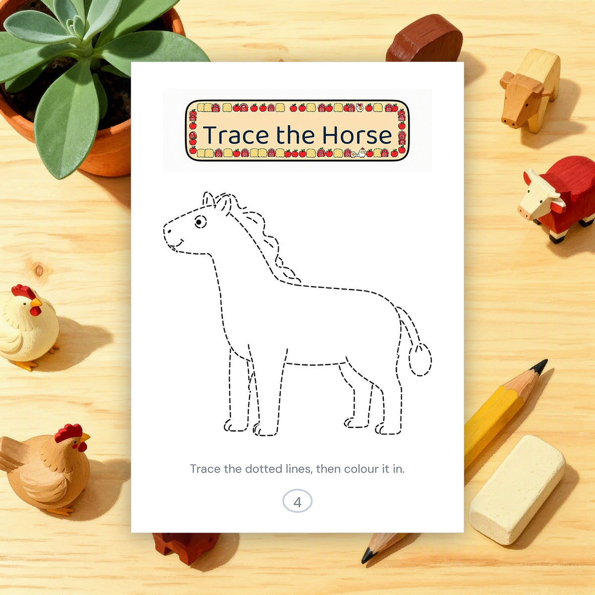 A printed horse tracing page on a wooden desk with a pencil and an eraser