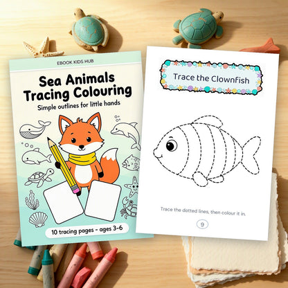 The book cover beside a printed clownfish tracing page and a stack of blank paper